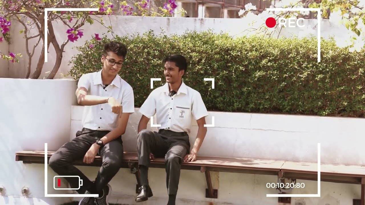 Two students sitting on a bench, smiling and recollecting their school journey at Babaji Vidhyashram CBSE School.