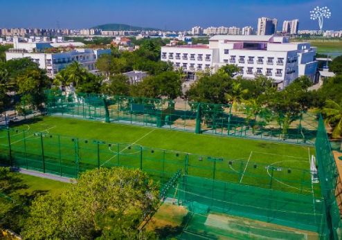 A bird's eye view of the Babaji Vidyashram School campus with a well appointed tennis court at the forefront