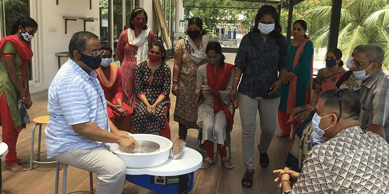 An interaction between potter and participants during pottery making workshop conducted at Babaji Vidhayasharam