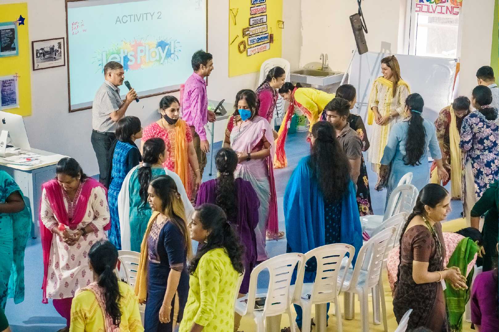 A set of school teachers are involved in a group activity and playing games happily in a school in Chennai